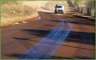 Significant reduction in dust generated by vehicle on a dirt road treated by FlowCentric Mining Technology